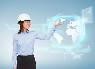 Image showing young smiling businesswoman in white helmet