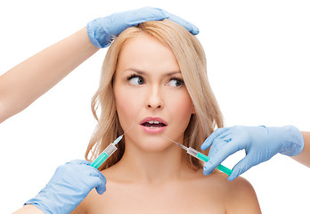 Image showing woman face and beautician hands with syringes