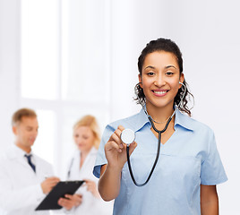 Image showing smiling female african american doctor or nurse