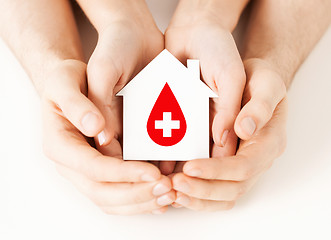 Image showing hands holding house with donor sign