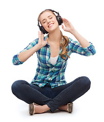 Image showing young woman listeting to music with headphones