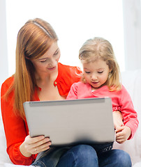 Image showing happy mother and daughter with laptop computer