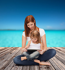 Image showing happy mother with little girl and tablet pc