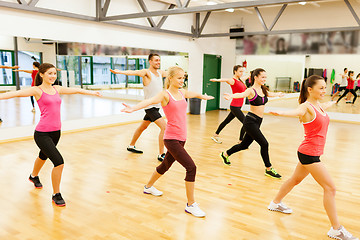 Image showing group of smiling people exercising in the gym