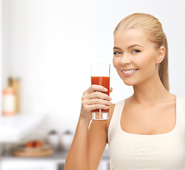 Image showing woman holding glass of tomato juice