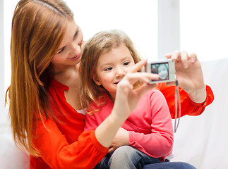 Image showing smiling mother and daughter taking picture