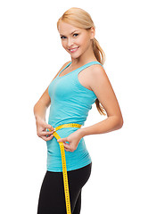 Image showing sporty woman with measuring tape