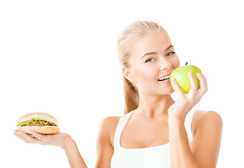 Image showing smiling woman with apple and hamburger