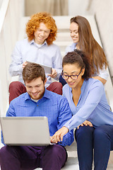 Image showing team with laptop and tablet pc on staircase