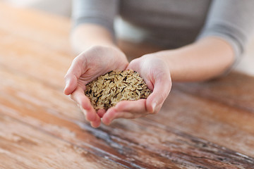 Image showing female with white and wild black rice on palm