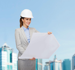 Image showing smiling architect in white helmet with blueprints