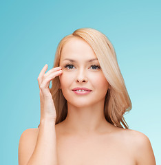 Image showing beautiful woman touching her eye area