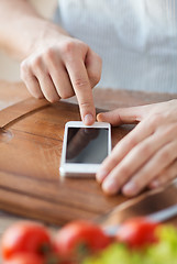 Image showing closeup of man pointing finger to smartphone