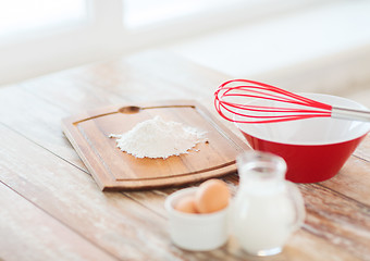 Image showing jugful of milk, eggs in a bowl and flour