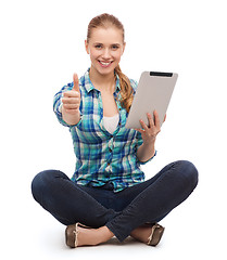 Image showing young woman in casual clothes sitting on floor