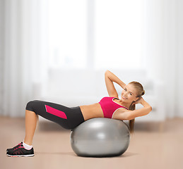 Image showing smiling woman with fitness ball at home