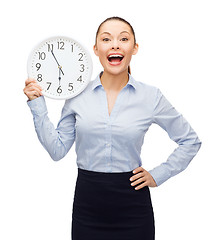 Image showing attractive businesswoman with wall clock