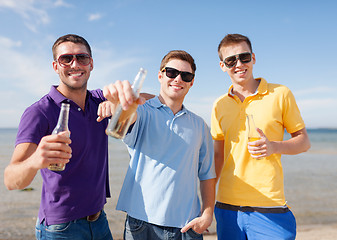 Image showing group of male friends with bottles of beer