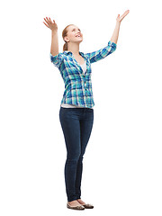 Image showing smiling young woman waving hands