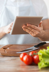 Image showing closeup of man pointing finger to tablet pc