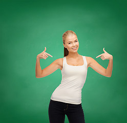 Image showing woman in blank white t-shirt pointing at herself