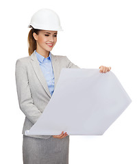 Image showing smiling architect in white helmet with blueprints