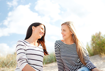 Image showing smiling girlfriends having fun on the beach
