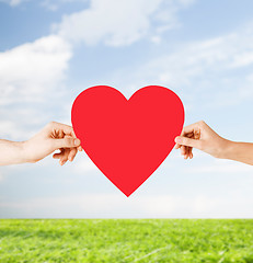 Image showing couple hands holding red heart