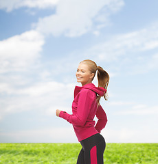 Image showing sporty woman running or jumping