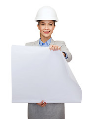 Image showing smiling architect in white helmet with blueprints