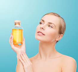 Image showing lovely woman with oil bottle