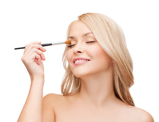 Image showing beautiful woman with closed eyes and makeup brush