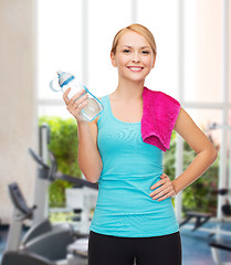 Image showing sporty woman with towel and watel bottle