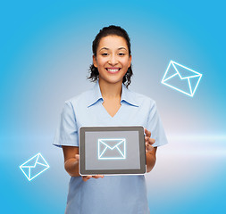 Image showing smiling female doctor or nurse with tablet pc