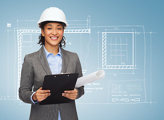 Image showing businesswoman in white helmet with clipboard