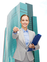 Image showing smiling businesswoman with folder and keys