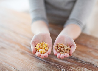 Image showing female hands with different pasta variations