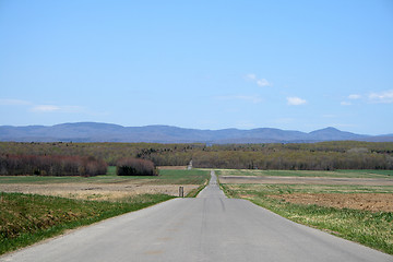 Image showing Country road leading to mountains