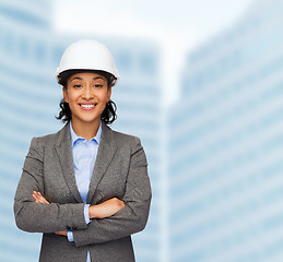 Image showing businesswoman in white helmet with crossed arms