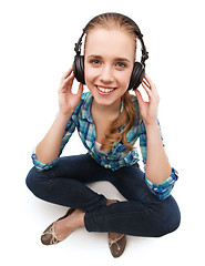 Image showing young woman listeting to music with headphones