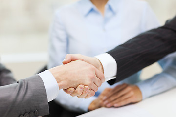 Image showing two businessmen shaking hands in office