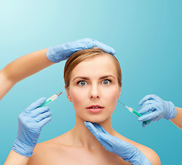 Image showing woman face and beautician hands with syringe