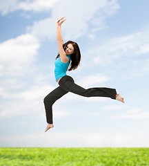 Image showing sporty woman jumping in sportswear