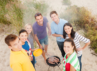 Image showing group of friends making barbecue on the beach