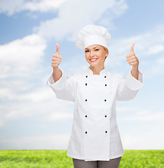 Image showing smiling female chef showing thumbs up