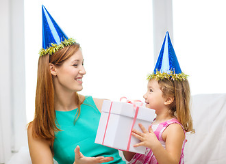 Image showing mother and daughter in blue hats with favor horns