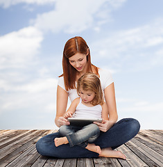 Image showing happy mother with little girl and tablet pc