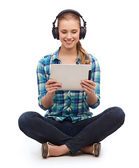 Image showing young woman in casual clothes sitting on floor