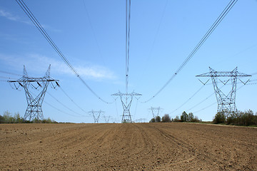 Image showing Electricity pylons in cultivated land