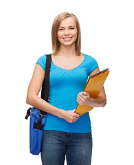 Image showing smiling female student with bag and folders